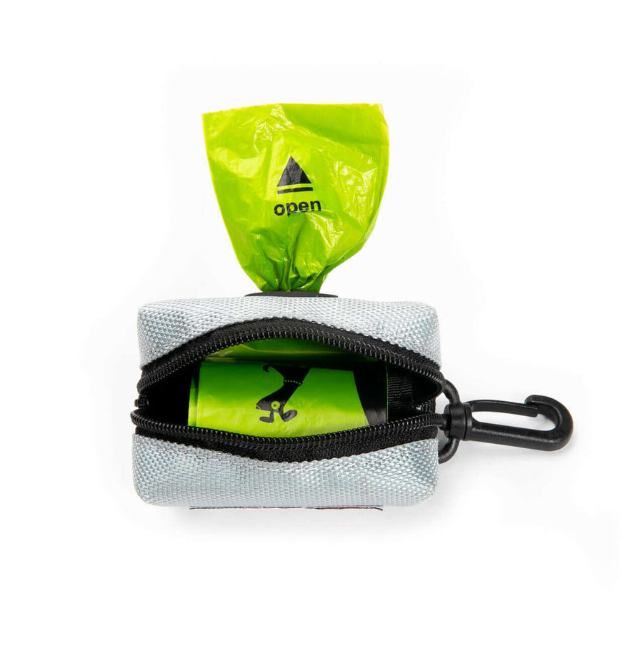 Leash Attachment Poop Bag Holder showing an open zipper with a poop bag and roll of potty bags inside.