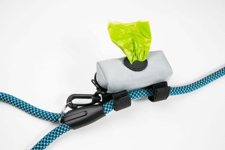 Leash Attachment Poop Bag Holder with a green poop bag visible, attached to a blue dog leash.