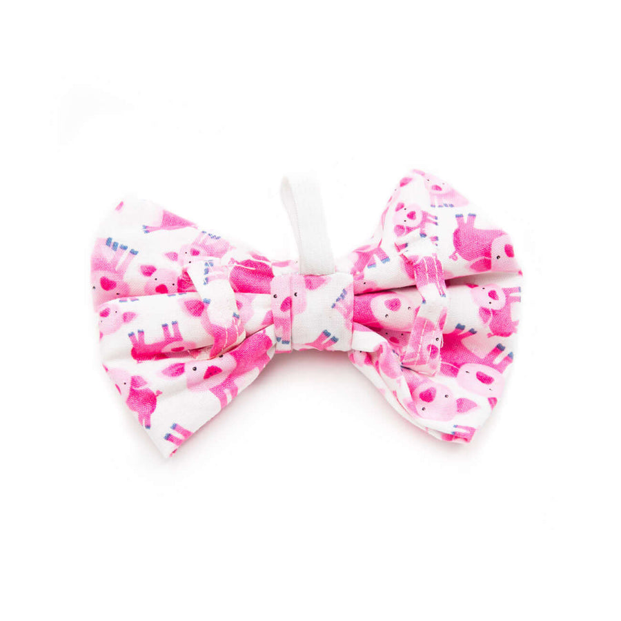 Pink Piglets Bowtie for dogs, featuring a unique pink piglet design and elastic loop for collar attachment.
